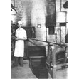 Arthur Gryfe standing at oven of S. Gryfe and Sons Bakery, 319 Augusta Ave., Toronto, [1931 or 1932]. Ontario Jewish Archives, Blankenstein Family Heritage Centre, item 4519.|Arthur Gryfe was the son of Sam Gryfe. Arthur and his wife Ruth went on to open Gryfe's Bagel Bakery on Bathurst Street in 1957.